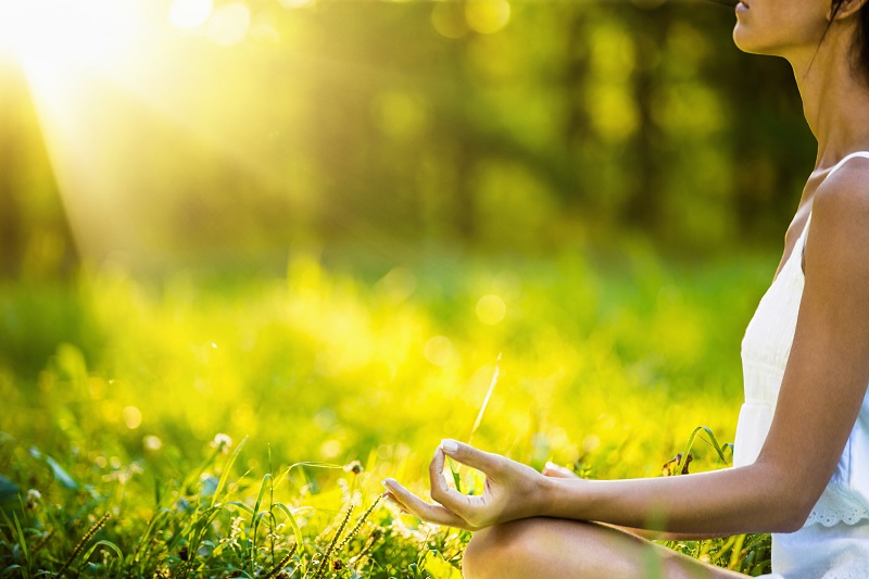 Yoga woman meditating at sunset. Female model meditating in serene harmony